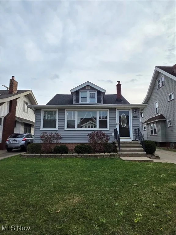 Bungalow-style house featuring a front lawn and a chimney