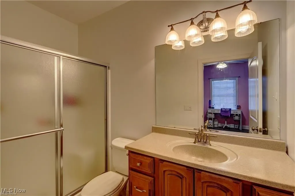 Bathroom featuring a shower stall and vanity