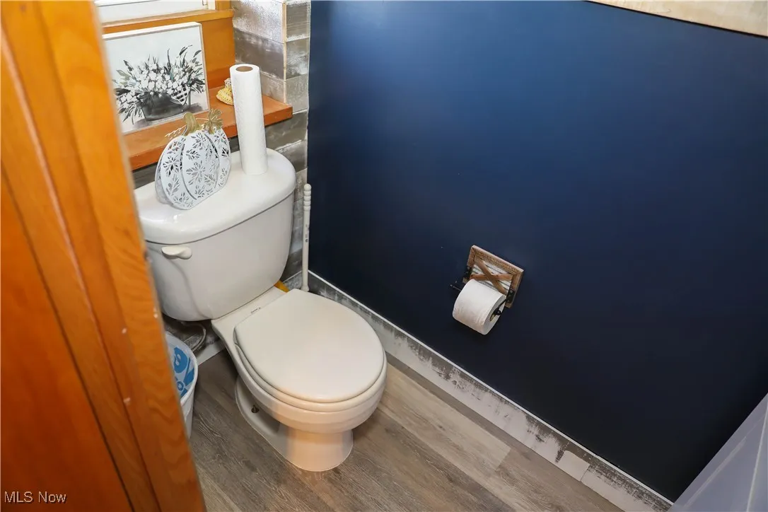 Bathroom featuring wood finished floors and toilet