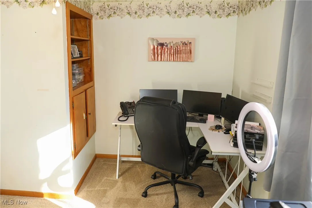 Office space with carpet floors and baseboards