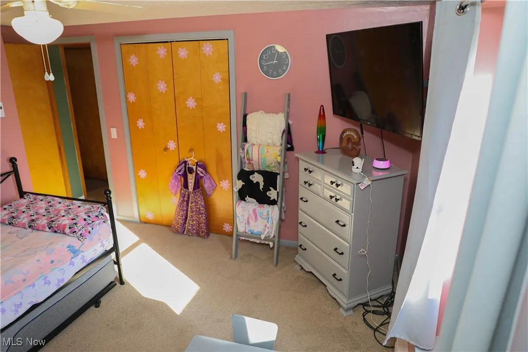 Bedroom featuring ceiling fan and light carpet