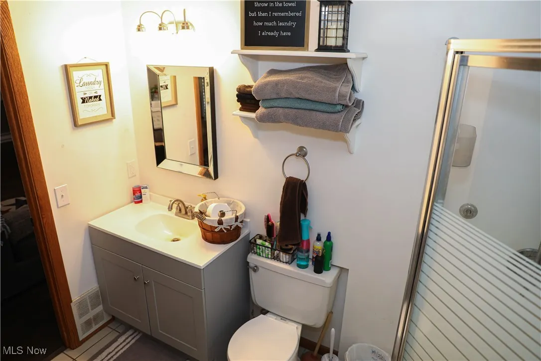 Bathroom with vanity and a shower stall