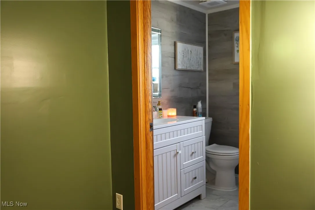 Bathroom with vanity and light marble finish flooring