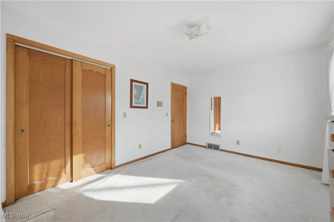 Unfurnished bedroom featuring carpet flooring and a closet