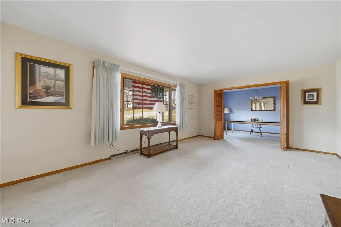 Empty room featuring carpet flooring and baseboards