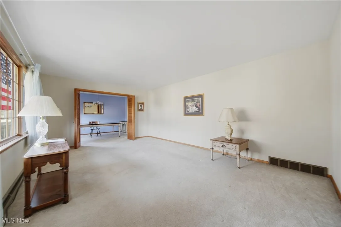 Living area with carpet flooring and baseboards