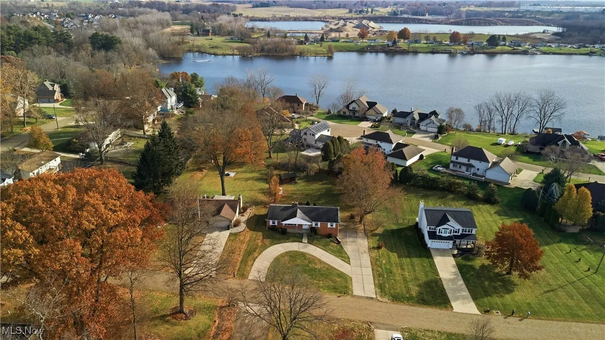 View of property location with a nearby body of water and nearby suburban area