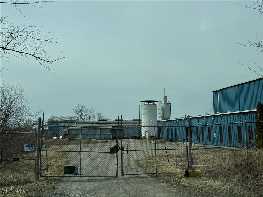 View of property's community with fence and a gate