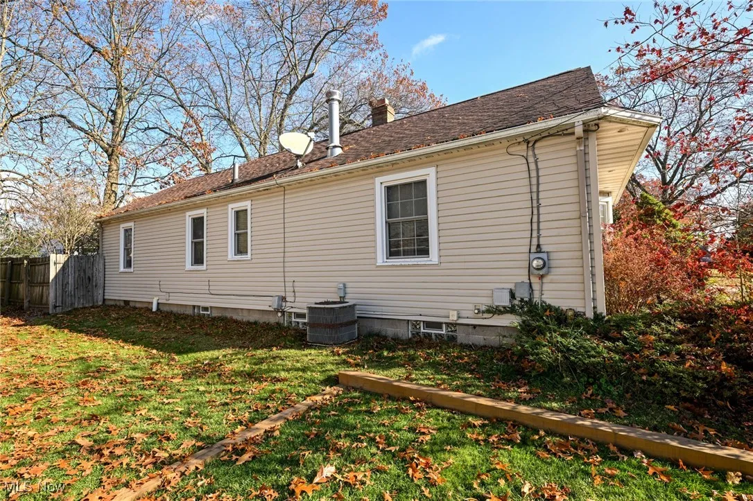 View of home's exterior featuring a chimney and a cooling unit