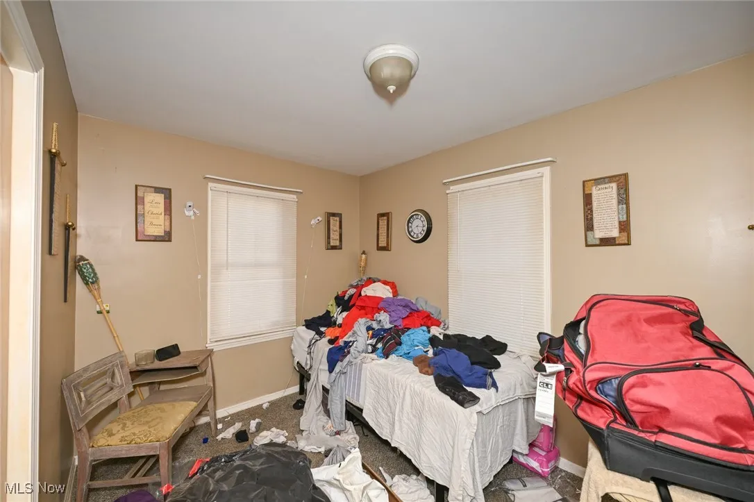 Bedroom featuring baseboards and carpet