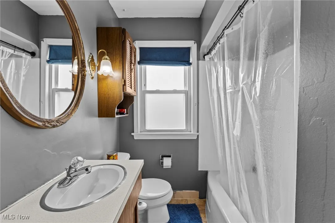 Full bath featuring vanity, and shower / bath combo