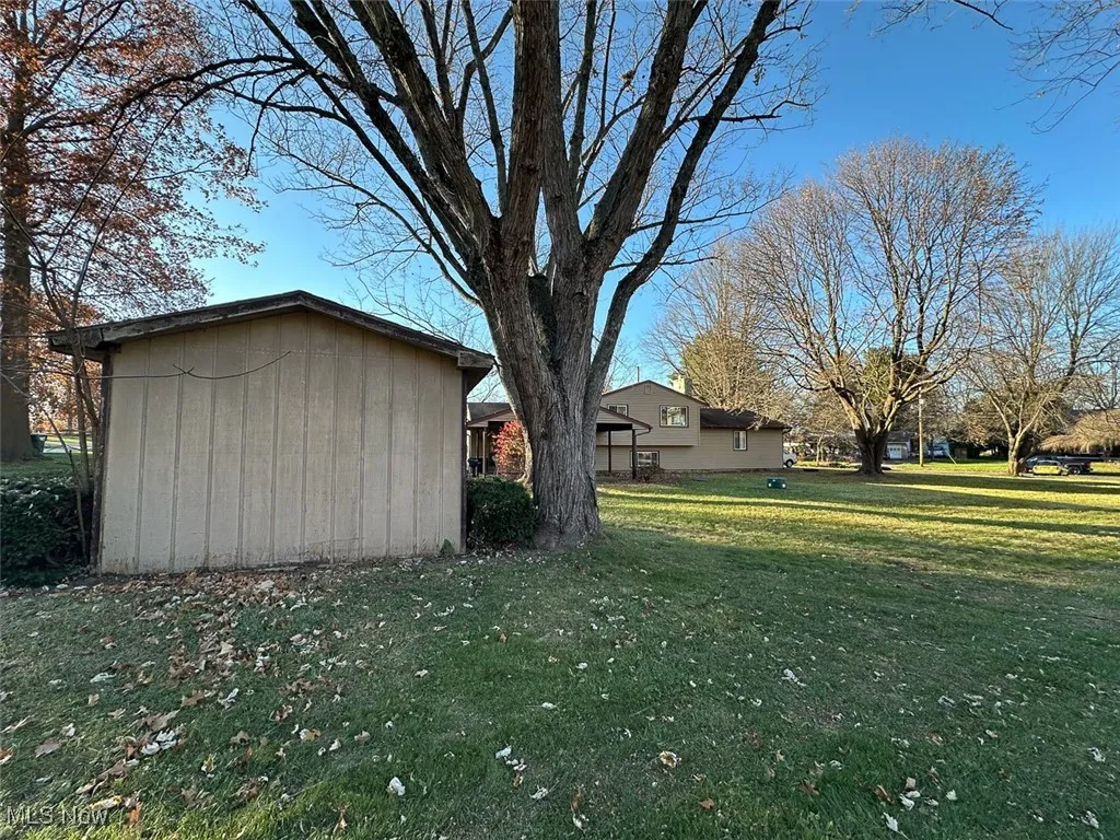 View of side of property featuring a yard
