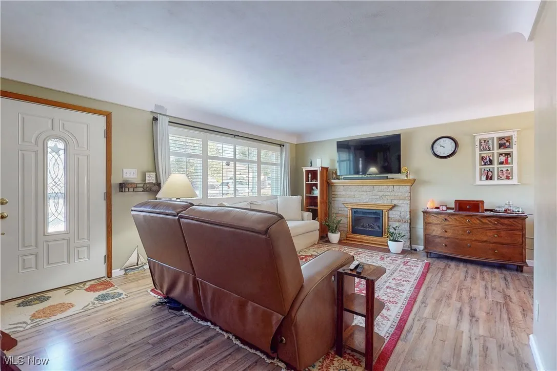 Living room featuring light wood-style flooring and a fireplace