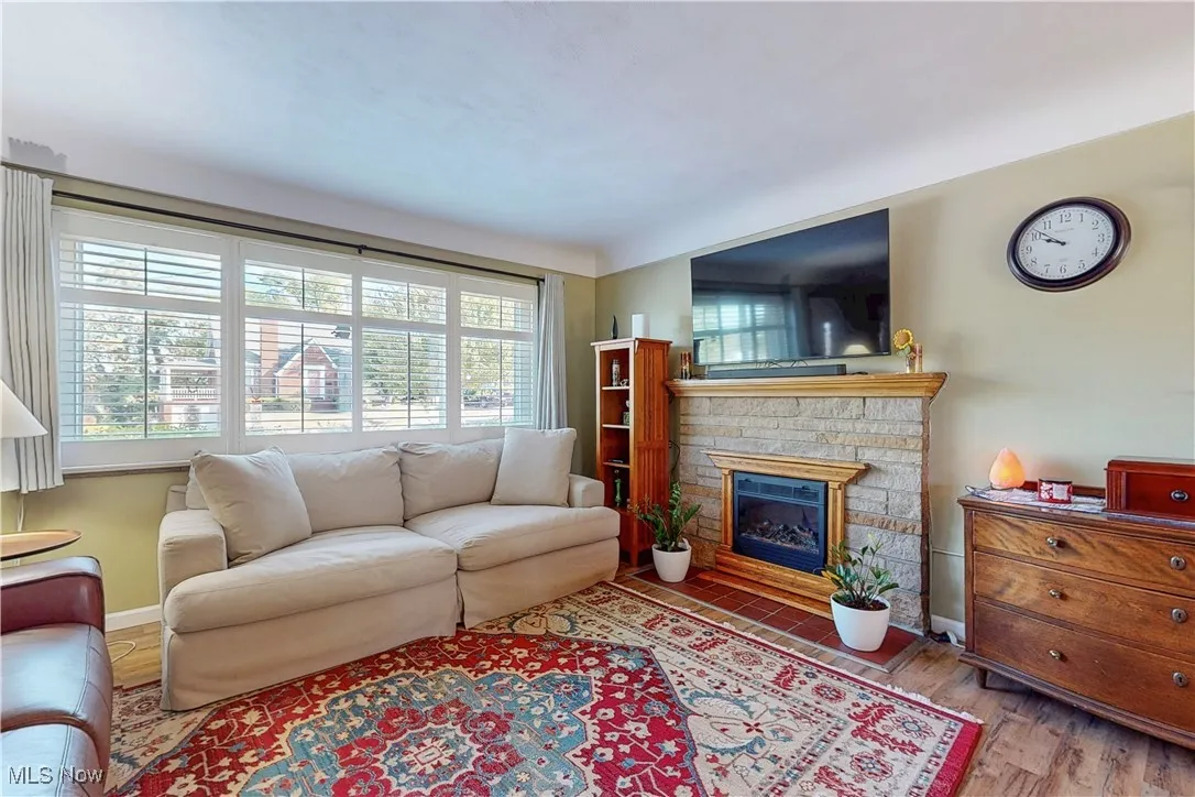Living area with a fireplace and wood finished floors