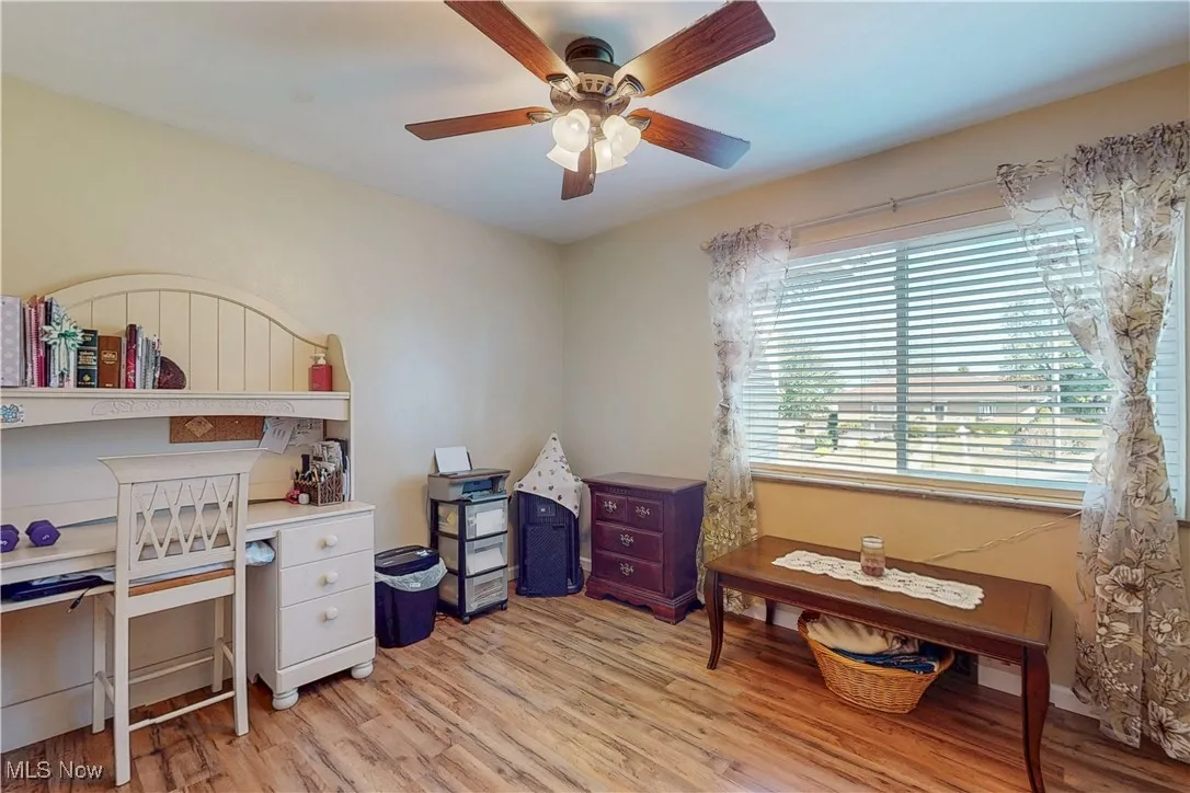 Office area featuring light wood-type flooring and a ceiling fan