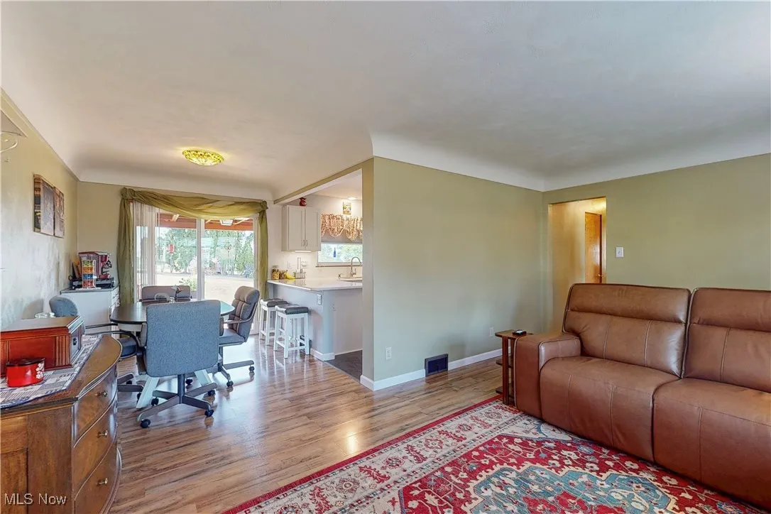 Living area featuring a desk and light wood-type flooring