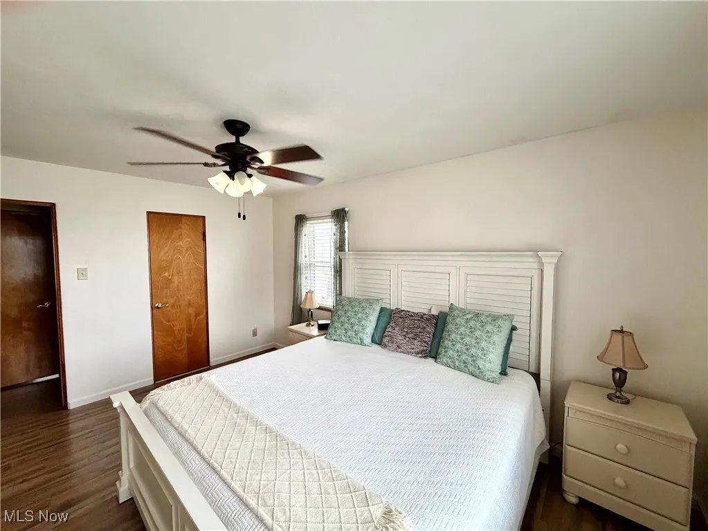 Bedroom featuring dark wood finished floors and ceiling fan