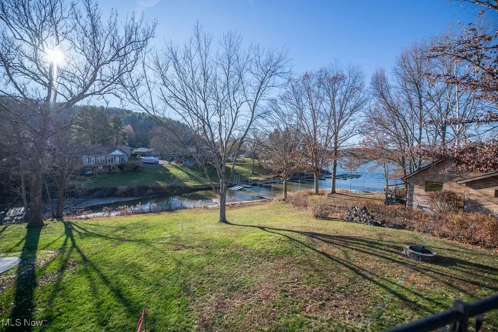 View of lake from back of home with large yard area