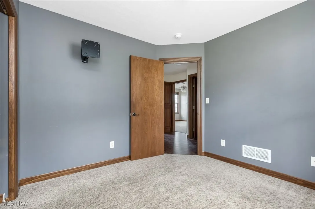 Spare room with carpet and baseboards