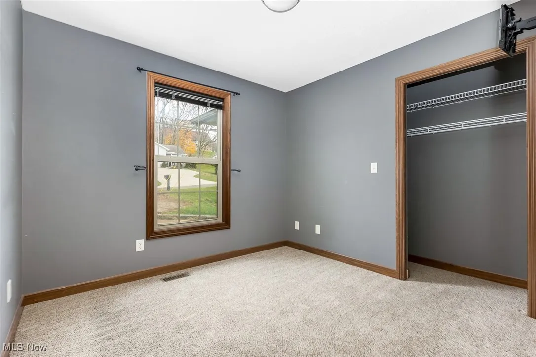Unfurnished bedroom with carpet floors and a closet