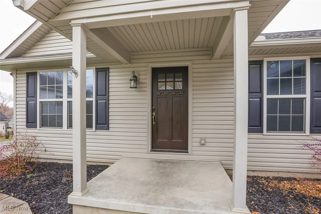 Property entrance with covered porch