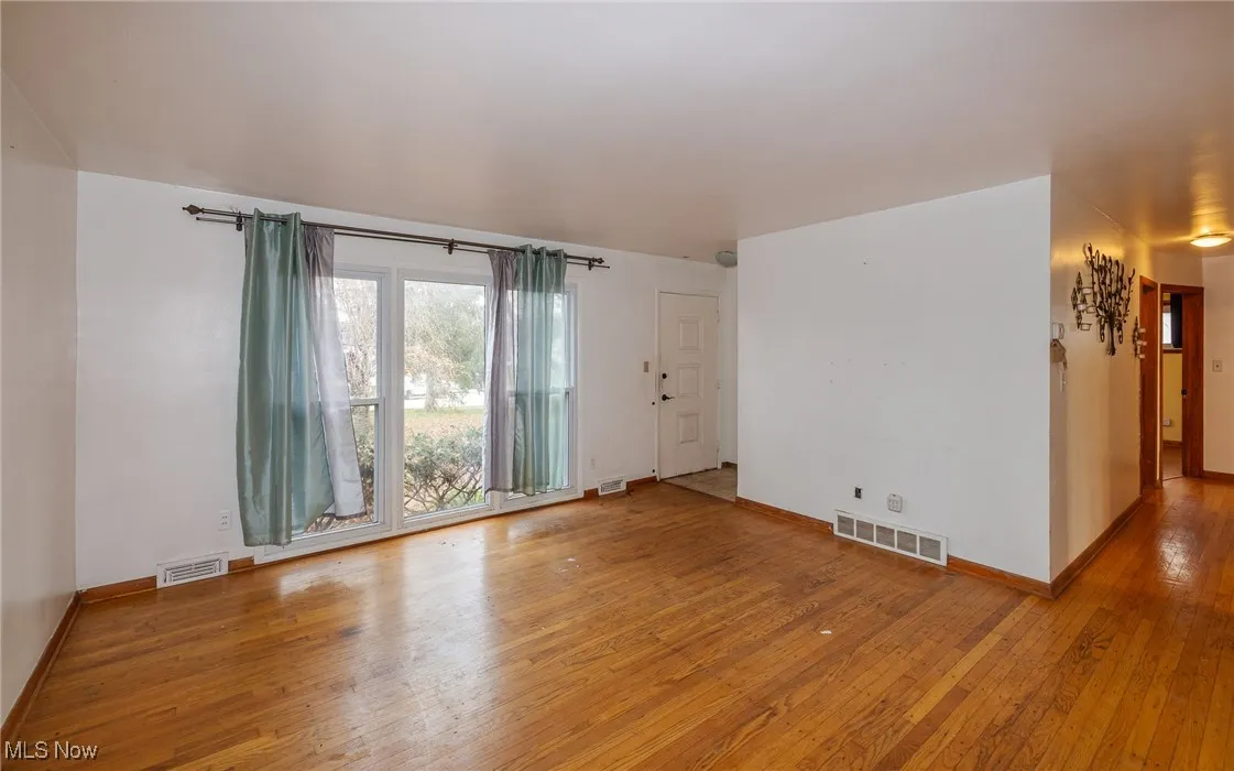 Empty room featuring light wood-style flooring and baseboards