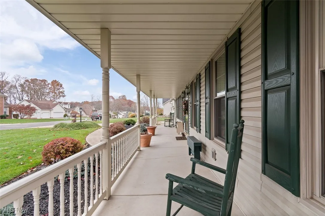 Covered porch featuring a residential view