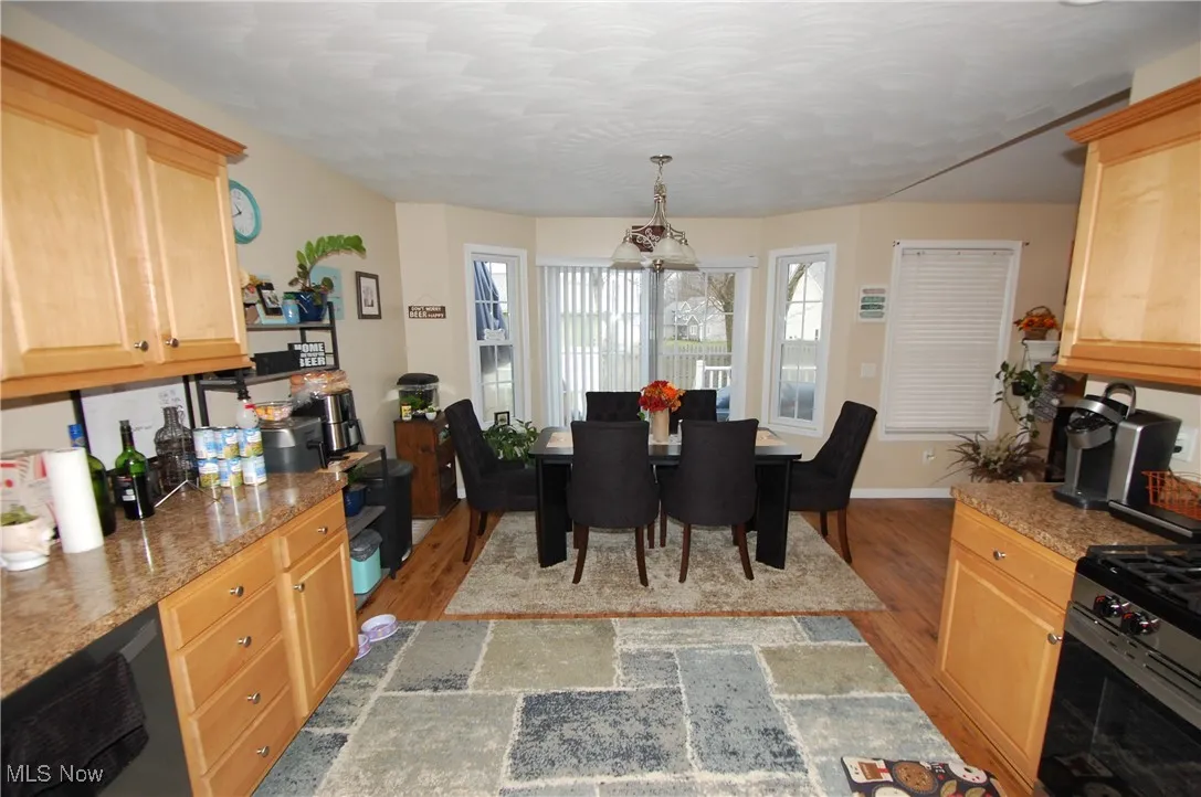 Dining space with light wood finished floors and baseboards