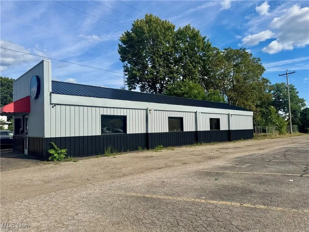 View of outbuilding with uncovered parking