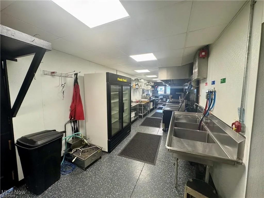 Kitchen with a drop ceiling and a sink