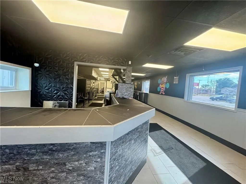 Reception with stairway and a wainscoted wall