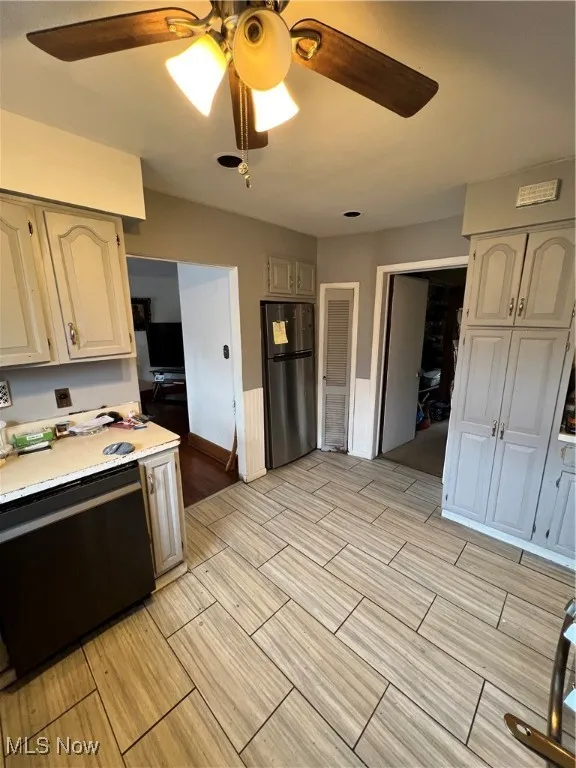 Kitchen featuring a ceiling fan, dishwashing machine, light countertops, refrigerator, and wood tiled floors