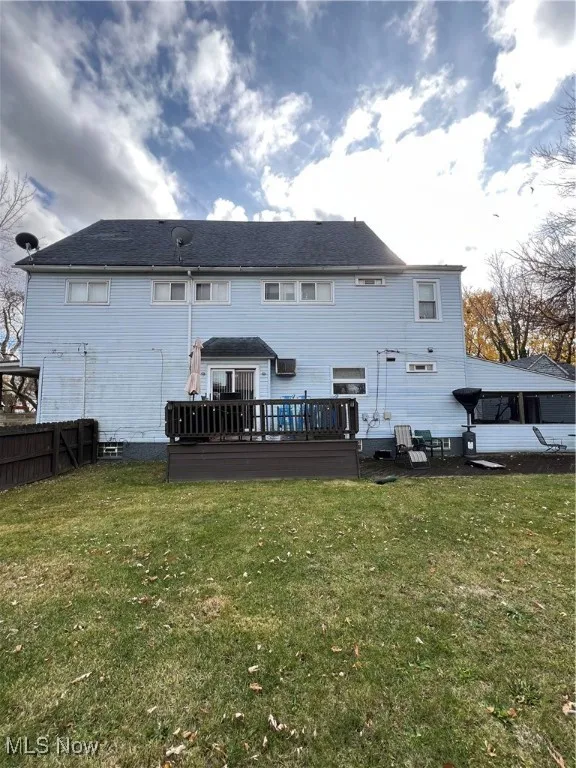 Rear view of property with a wooden deck and a​​‌​​​​‌​​‌‌​‌‌​​​‌‌​‌​‌​‌​​​‌​​ lawn