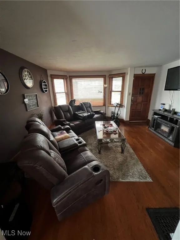 Living area featuring healthy amount of natural light and dark wood-style flooring