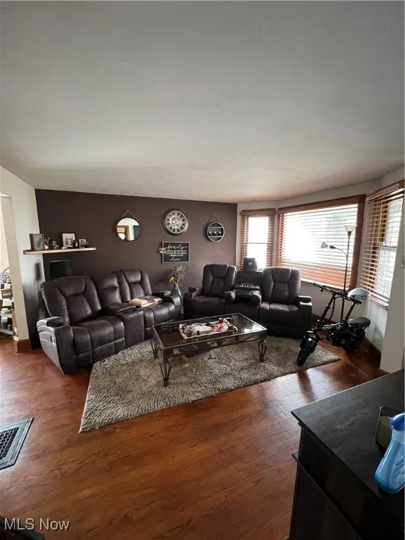 Living area with dark wood-type flooring