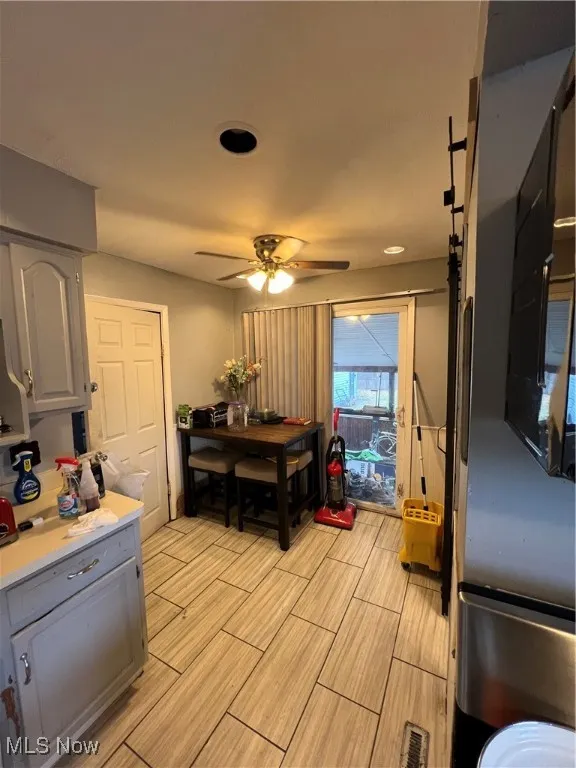 Dining area featuring a ceiling fan and wood finish floors