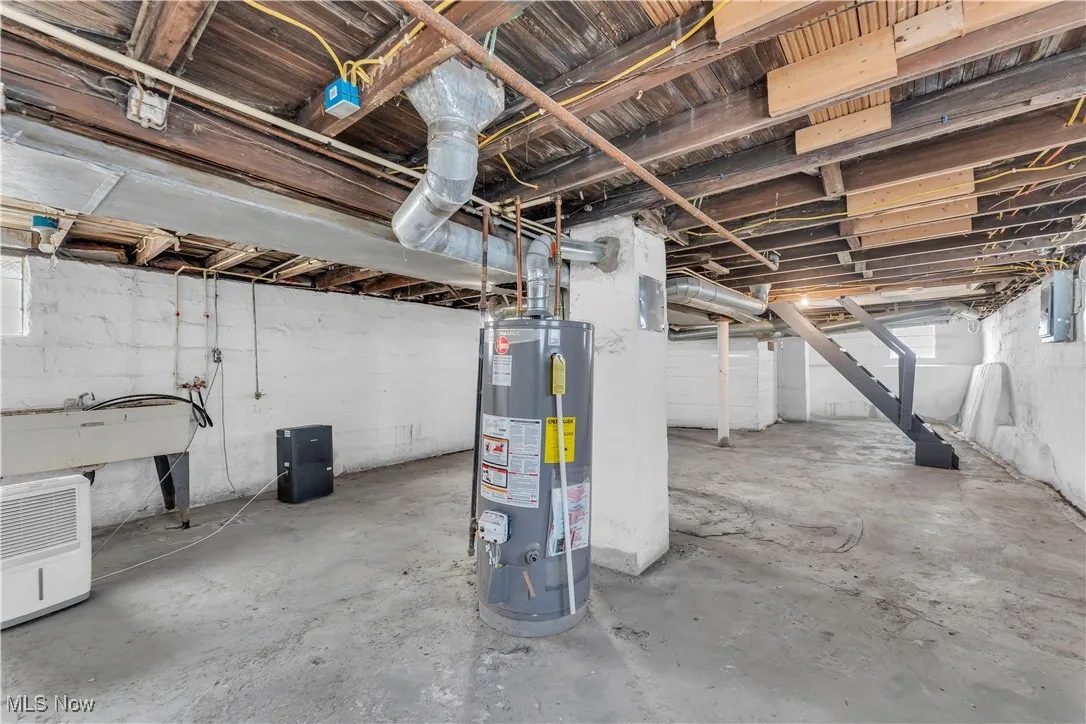 Basement featuring water heater and electric panel