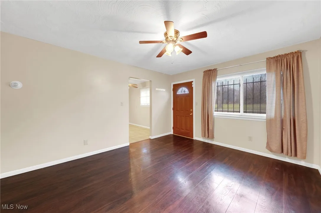 Entrance foyer featuring dark wood finished floors and a ceiling fan