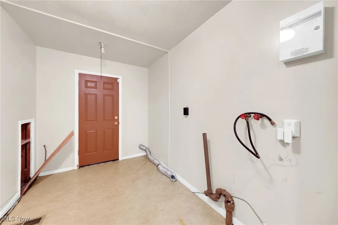Laundry area featuring tile patterned floors