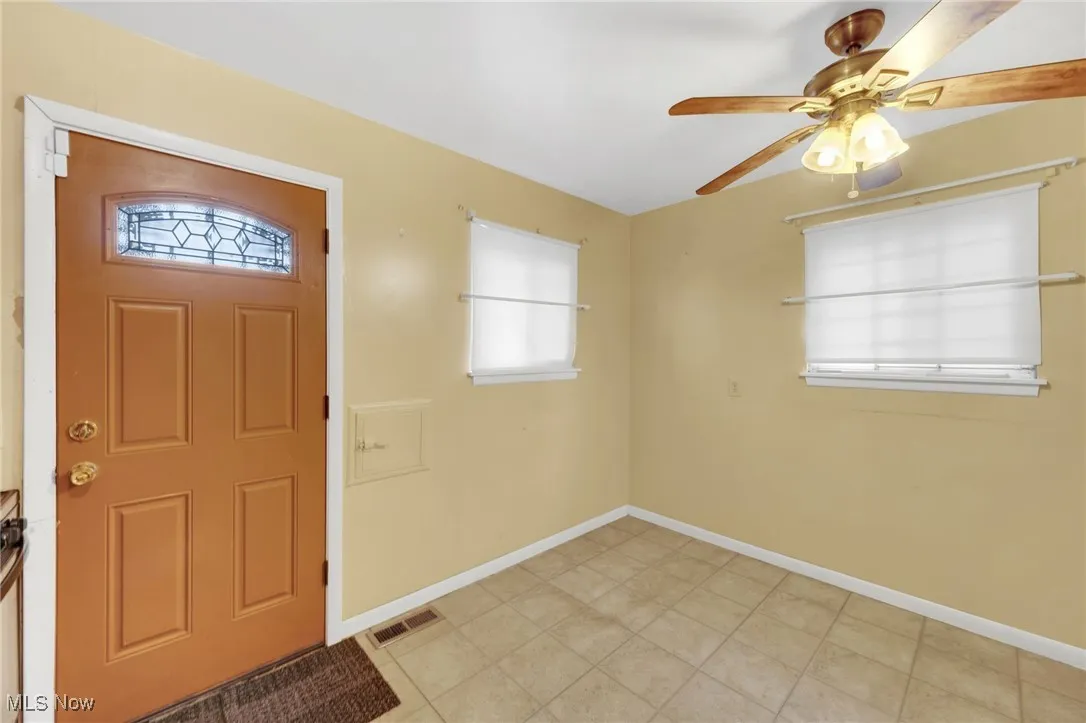 Entrance foyer featuring healthy amount of natural light and ceiling fan
