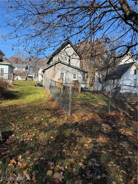 View of side of home with a fenced backyard