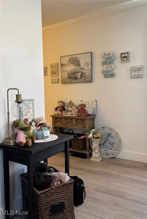 Dining space featuring crown molding and wood finished floors