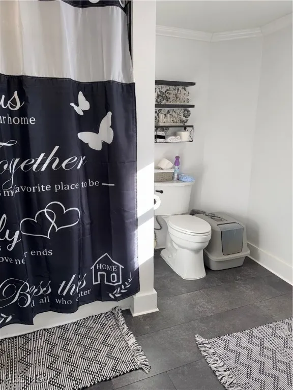 Full bathroom with a shower with curtain and crown molding