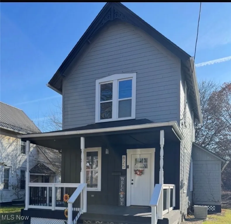 View of front of property with covered porch and board and batten siding