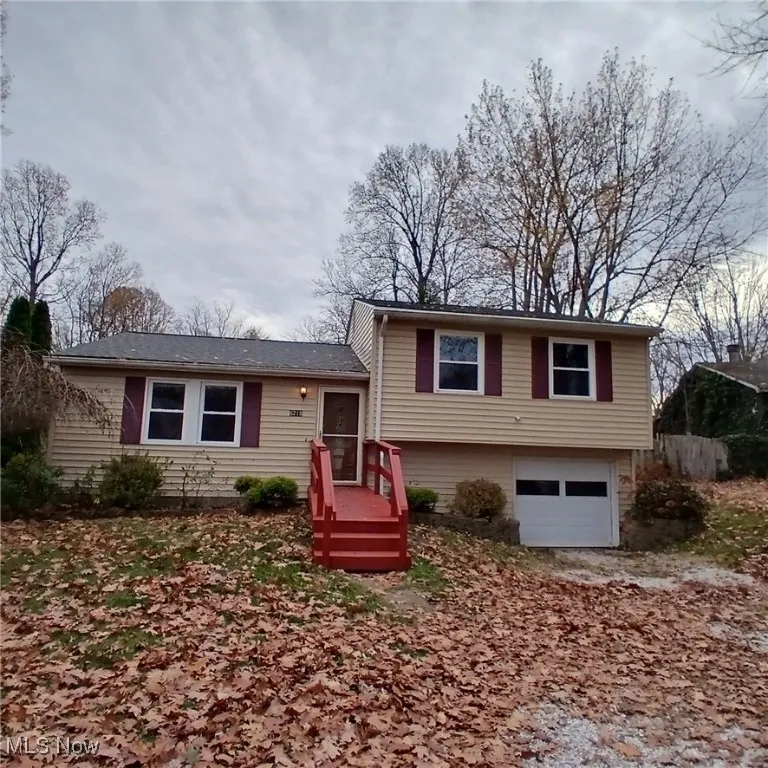 Split level home featuring an attached garage and driveway