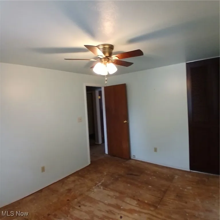 Spare room with ceiling fan