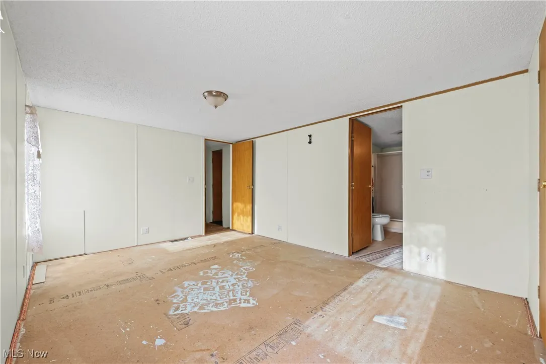 Unfurnished bedroom with a textured ceiling