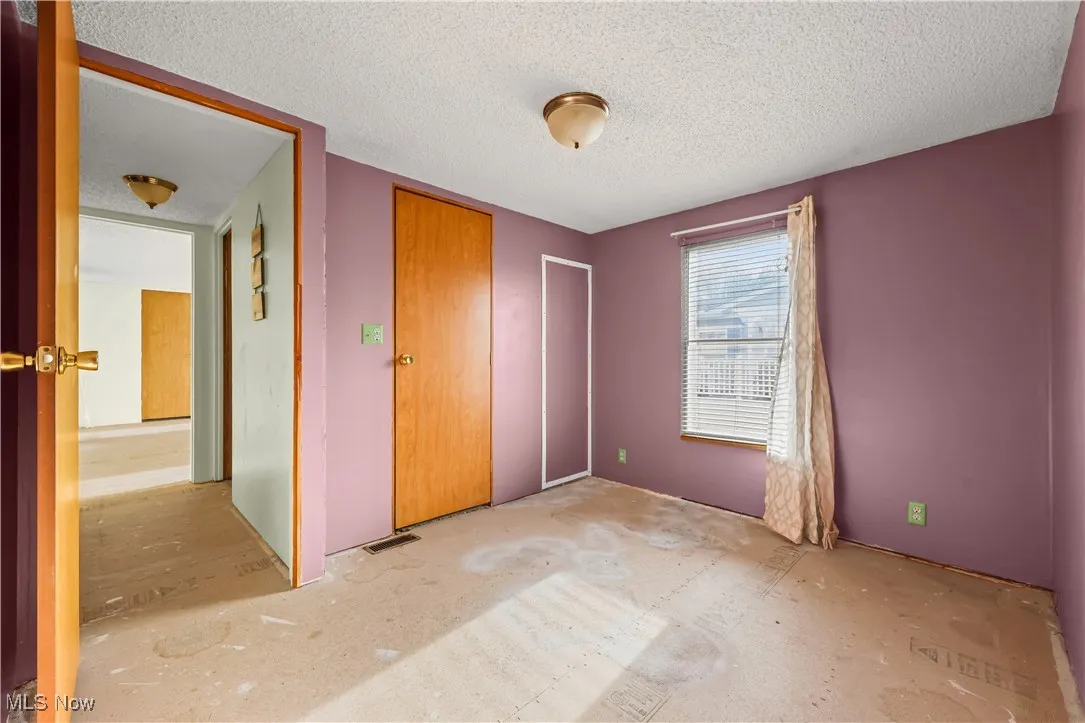 Unfurnished bedroom with a textured ceiling