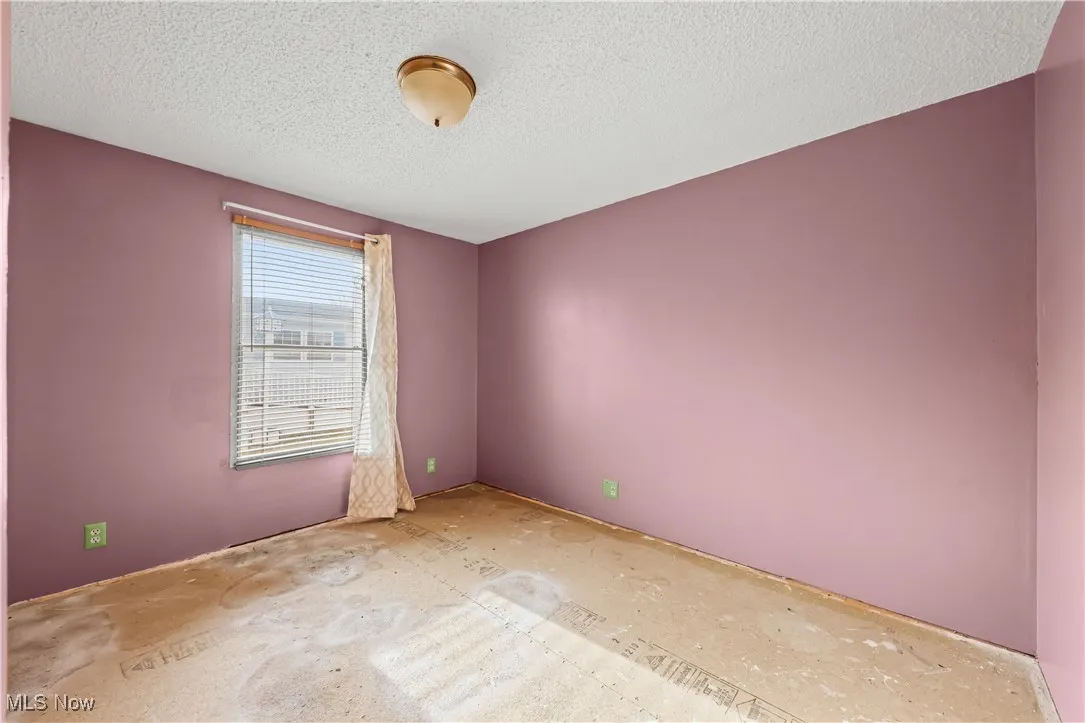 Spare room with a textured ceiling