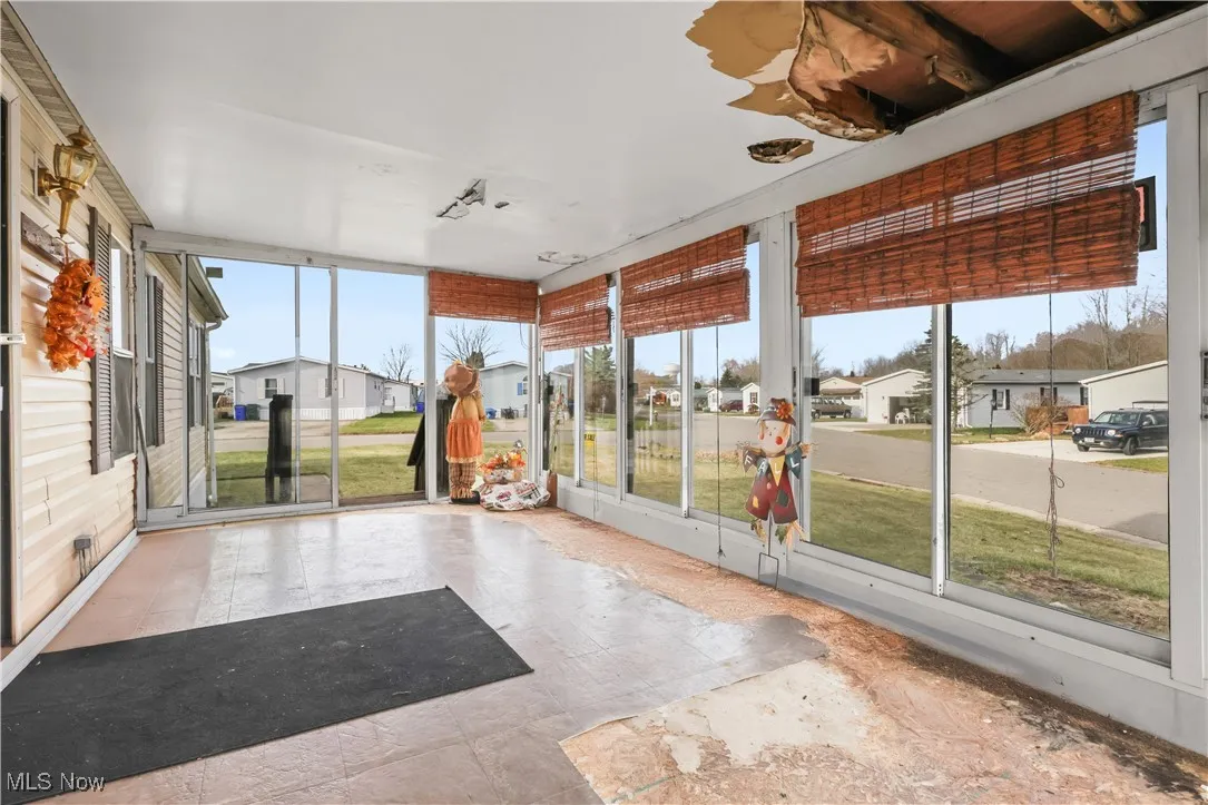Unfurnished sunroom featuring a residential view